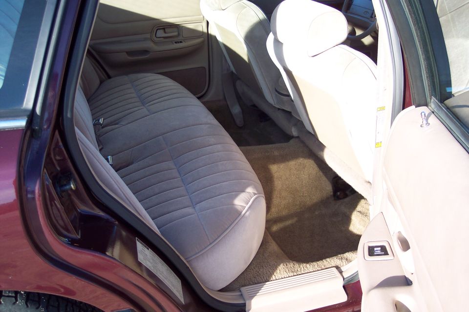 Interior of a sedan showing rear and front seats.