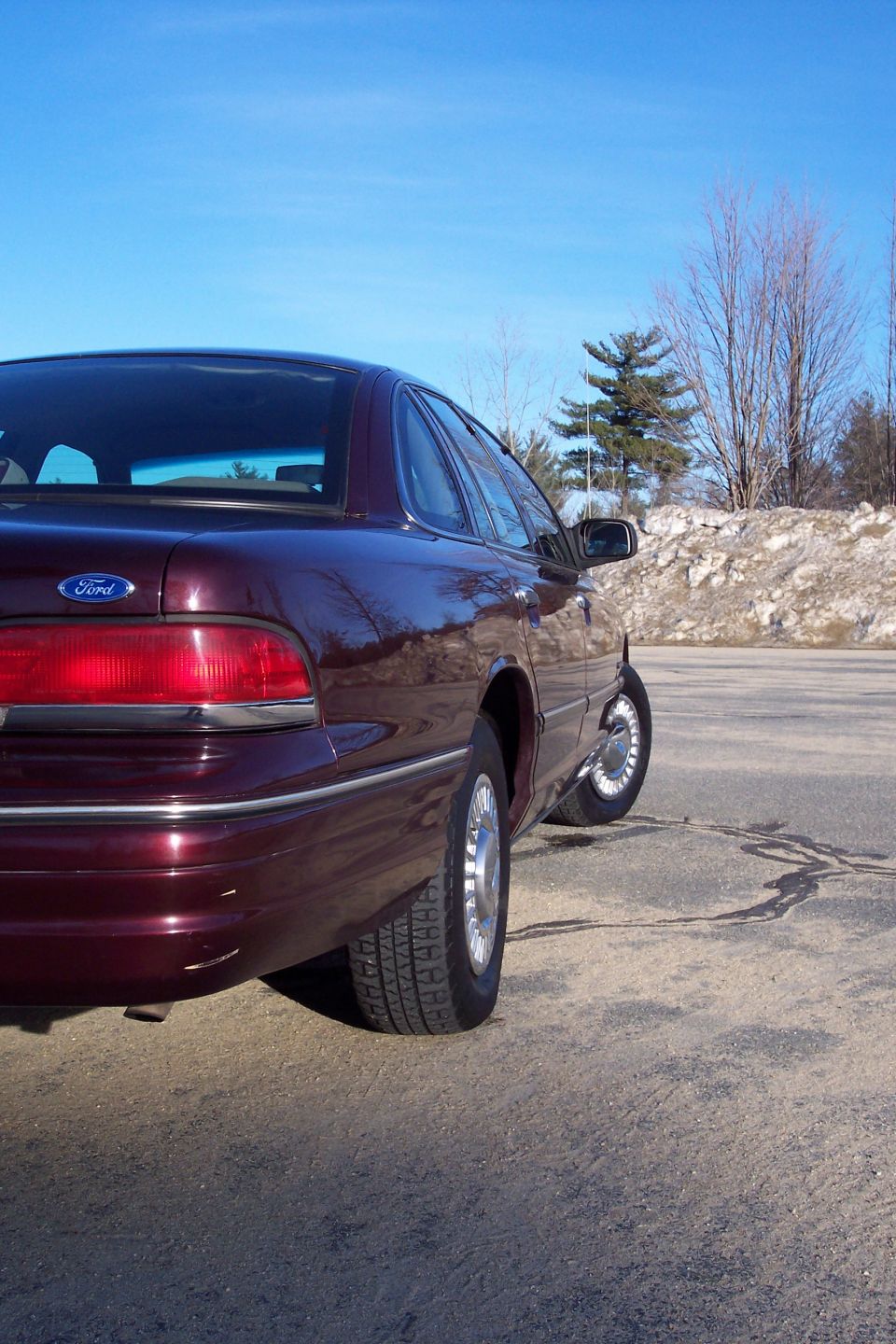 Maroon 2001 Ford Crown Victoria, rear passenger side view.
