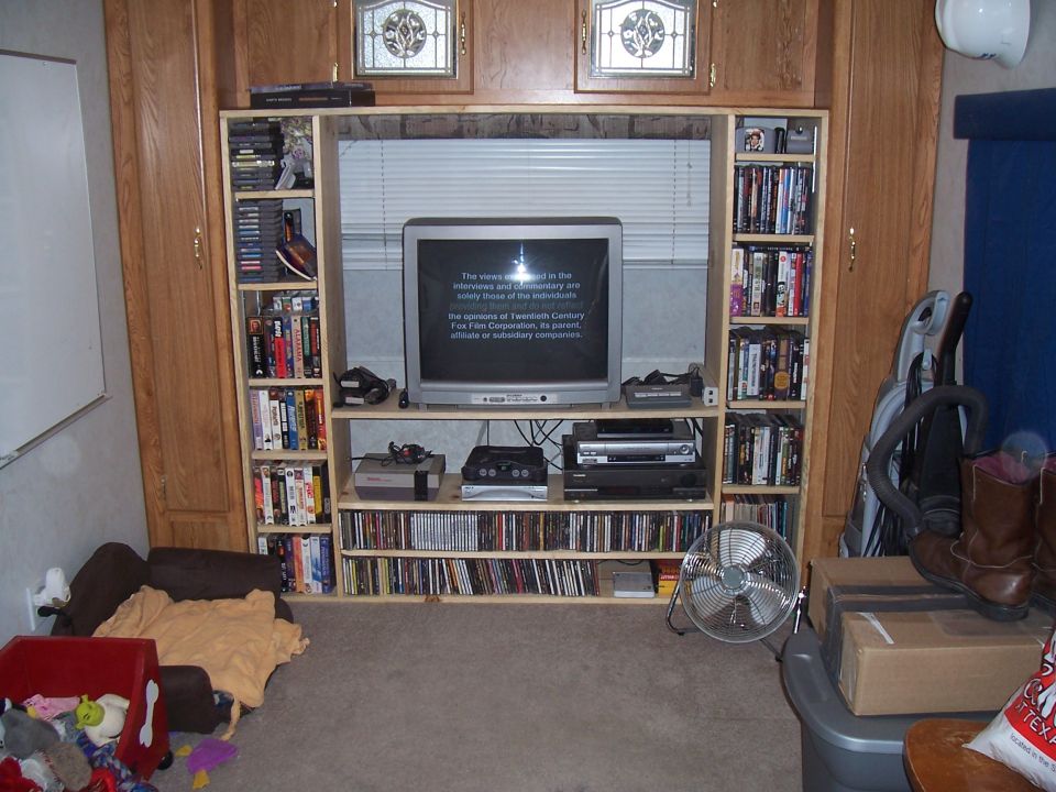 Living room entertainment center with TV, DVDs and bookshelves