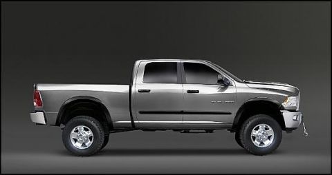 1989 Ford Bronco - A silver four-door pickup truck is shown in a side profile against a dark gray background. The truck has large tires, chrome wheels, and bl…