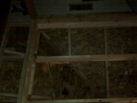 2005 Ford Mustang - This image shows the interior framing of a building under construction. The walls are covered with oriented strand board (OSB) and supporte…