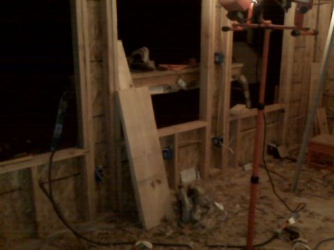 2005 Ford Mustang - This is an image of an unfinished interior construction site. There is lumber, electrical boxes, and a portable work light visible.