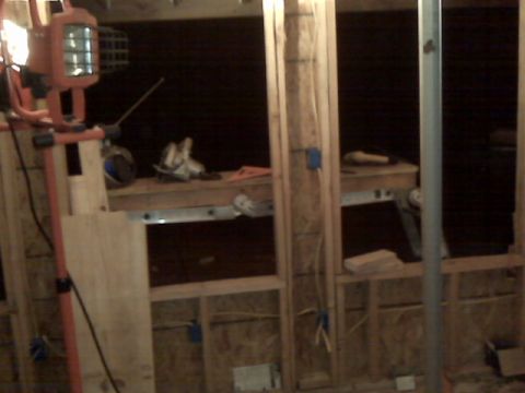 2005 Ford Mustang - This image shows a construction scene with wooden framing, electrical wiring, and a portable work light. Tools and materials are visible on…