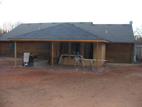 2005 Ford Mustang - This image shows the exterior of a house under construction with a covered patio area. There is a grill on the left side of the patio and v…