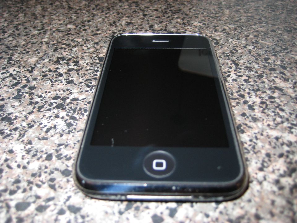 Black smartphone on a speckled countertop