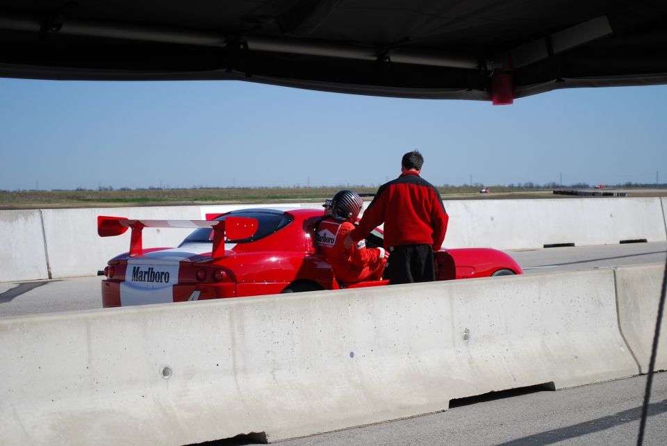 Red Marlboro-liveried race car on a track
