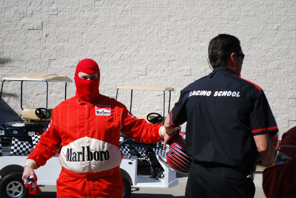 Person in red costume with white belt, person in black uniform with 'POLICE' text, blurred background