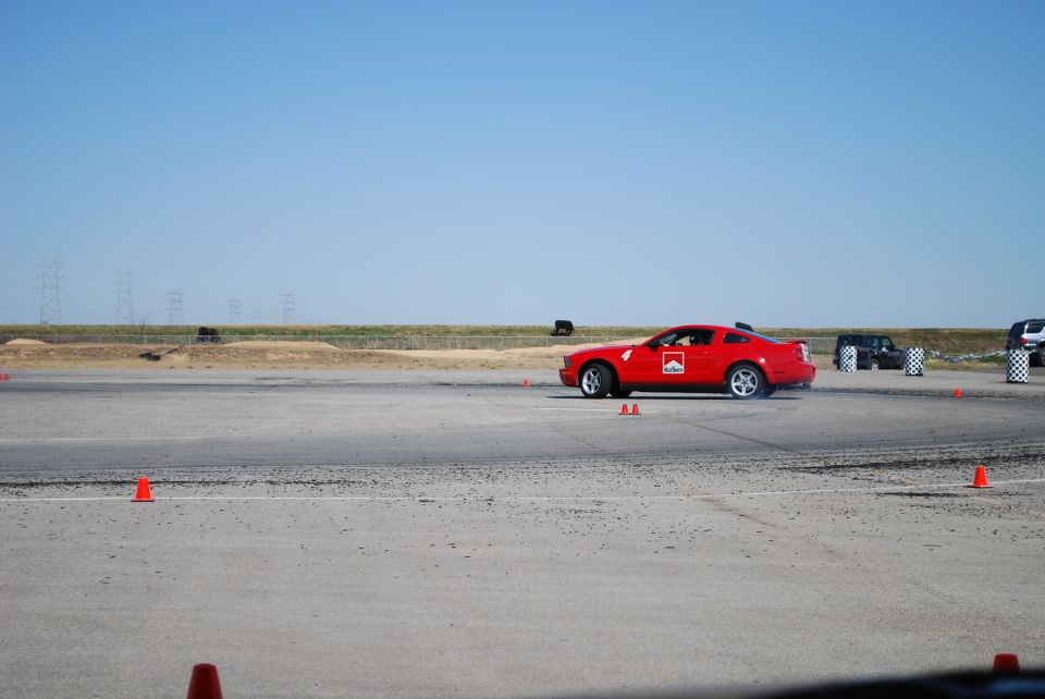 Red sports car with Marlboro logo on side, driving on a track. Visible text: SUPERMOTORS.NET