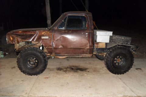 1980 Dodge Magnum - This heavily modified pickup truck features a flatbed conversion and oversized tires, suggesting off-road use. The body shows considerable…