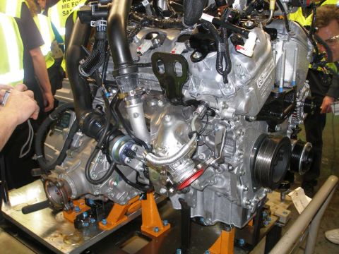 1997 Ford Taurus - Engine assembly on orange stands, with visible turbocharger and drive belts.
