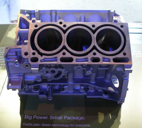 1997 Ford Taurus - Engine block on display with text about Ford's plan for green technology.
