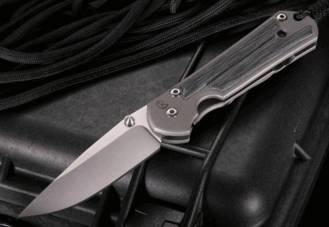 2000 Ford Crown Victoria - A close-up view of a folding knife with a textured handle and a sharp blade.