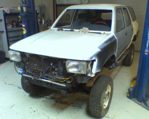1993 Toyota 4Runner - This 1993 Toyota 4Runner is undergoing repairs in a garage, with its front end partially dismantled.