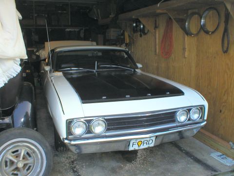 1983 Ford Bronco - The second part of the set: a restored white Talladega that he also drives. With a blue one, he'd finish the set.