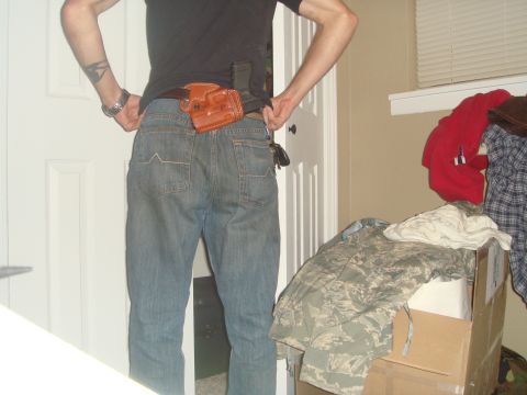 1992 Ford Bronco - A person is shown from behind wearing jeans and a holster on their hip.