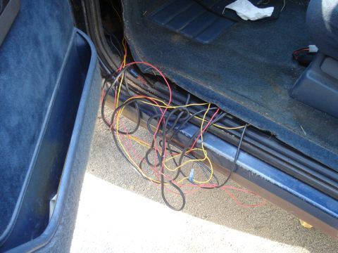 1984 Jeep J-10 - A chaotic tangle of wires is visible inside the vehicle, near the driver's side door and seat.