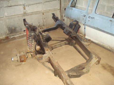 1991 Ford Bronco - This image shows a drivetrain and axle assembly, likely from a truck or SUV, with a red shock absorber visible.