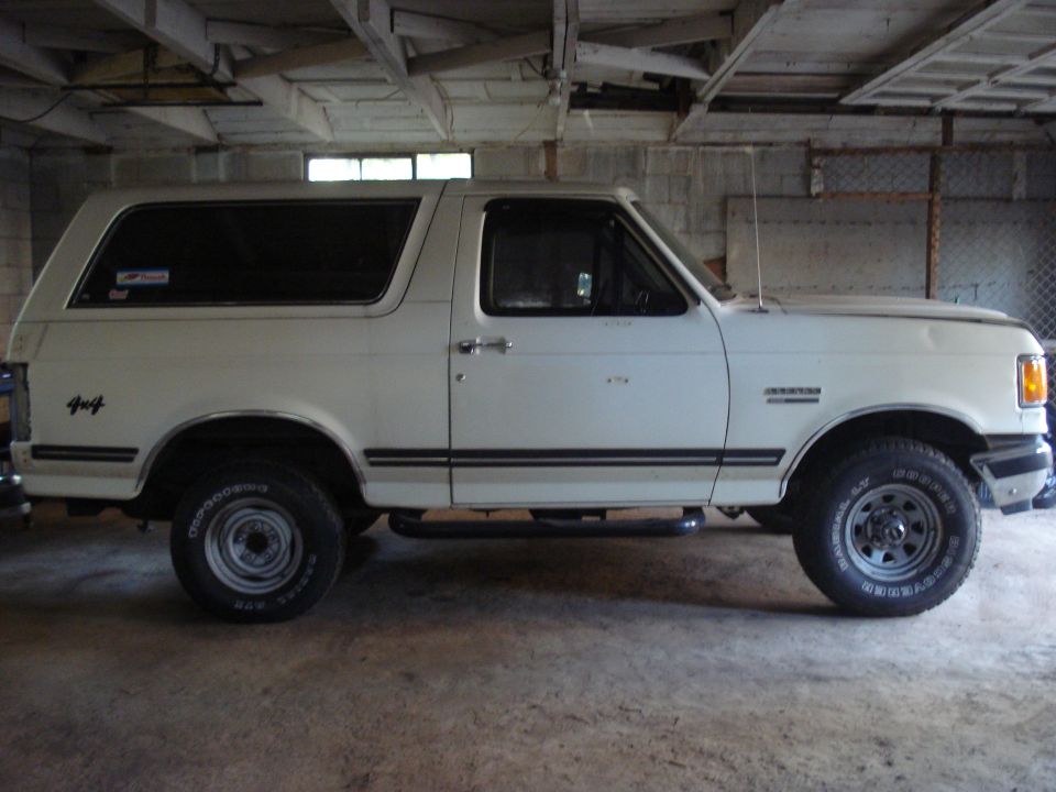 White 1991 Ford Bronco side view with 4x4 decal
