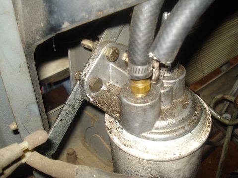 1991 Ford Bronco - This image shows a close-up of a vehicle's fuel filter assembly, including hoses and mounting hardware.