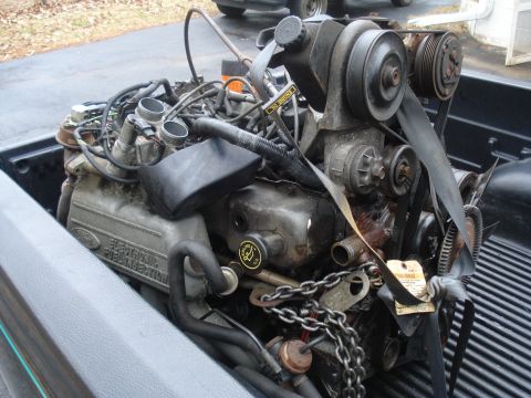 1991 Ford Bronco - A Ford V8 engine, labeled "Electronic Fuel Injection", is pictured in the bed of a truck.