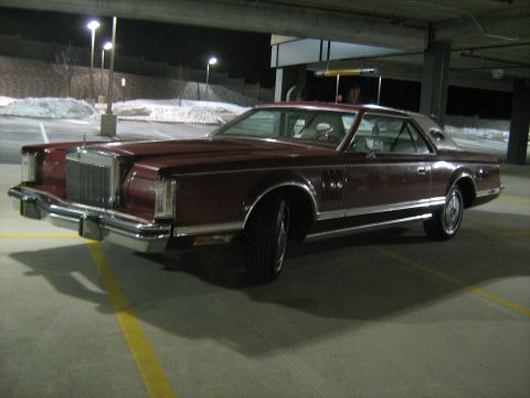 1988 Mercury Grand Marquis - Maroon Lincoln Continental Mark VII parked in a dimly lit parking garage at night.