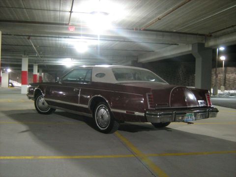 1988 Mercury Grand Marquis - Maroon Lincoln Continental Mark VII with a tan vinyl roof parked in a garage.