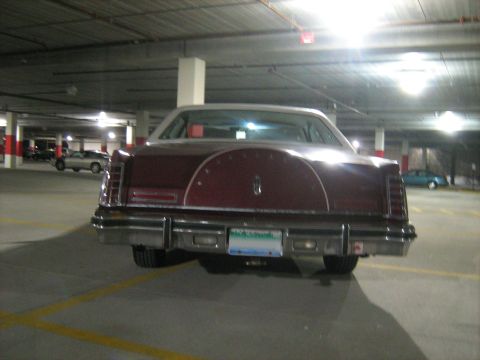 1988 Mercury Grand Marquis - Maroon Lincoln Continental Mark V with a continental kit parked in a garage.