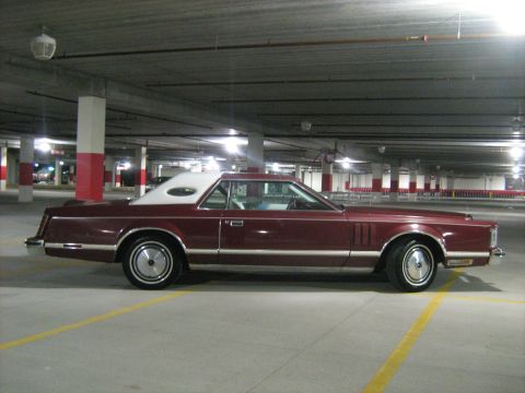 1988 Mercury Grand Marquis - A maroon Lincoln Continental Mark V is parked in a dimly lit parking garage.