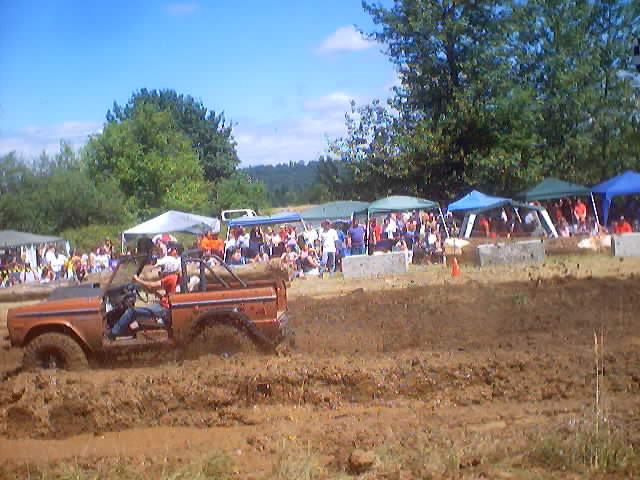 Orange 1976 Ford F-100 Bronco in mud pit