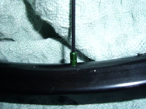 1972 Ford Ranchero - Detail of a bicycle wheel showing a spoke and rim, with a textured fabric in the background.