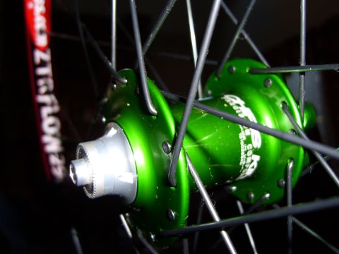 1972 Ford Ranchero - Close-up of a bicycle wheel hub, showing its metallic green finish and spokes.
