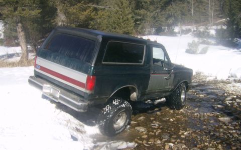 1990 Ford Bronco - This 1990 Ford Bronco navigates a snowy and rocky path, its off-road capabilities.