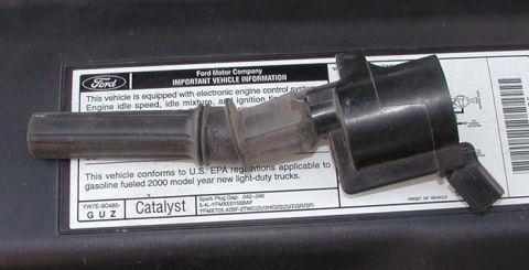 2007 Ford Mustang - Ignition coil sits on a vehicle information sticker that specifies 2000 model year light-duty trucks.