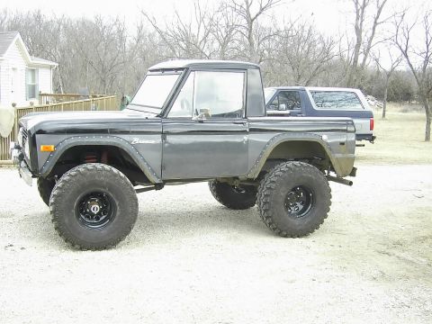 1978 Ford Bronco - A modified 1978 Ford Bronco sits parked next to another SUV.