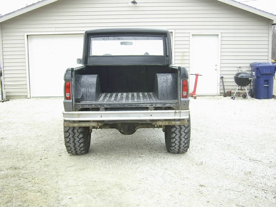 Rear view of a black 1978 Ford Bronco with a lifted suspension and large tires