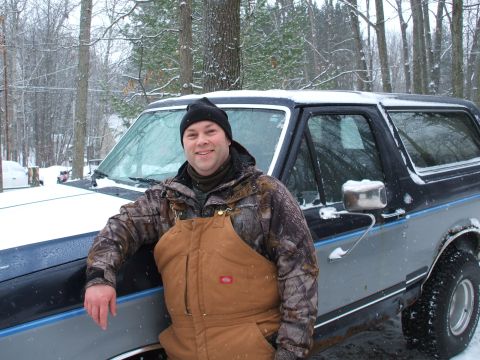 1990 Ford Bronco - Man poses with his 1990 Ford Bronco during a snowy day.