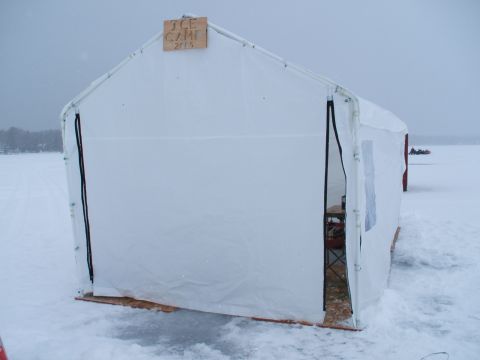 1990 Ford Bronco - A white tent with 'ICE CAMP 2015' signage is set up on a frozen body of water.