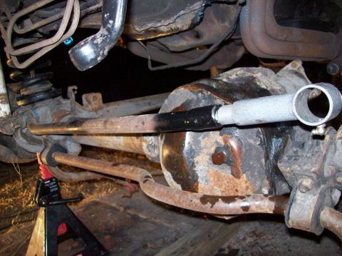1986 Ford Bronco - Close-up of a vehicle's undercarriage, showing suspension parts and a differential.