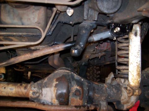 1986 Ford Bronco - Undercarriage view shows the front axle, steering components, and suspension of a vehicle.