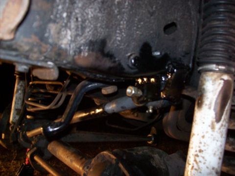 1986 Ford Bronco - Close-up view of vehicle undercarriage suspension components, with "SUPERMOTORS" visible at the bottom right.