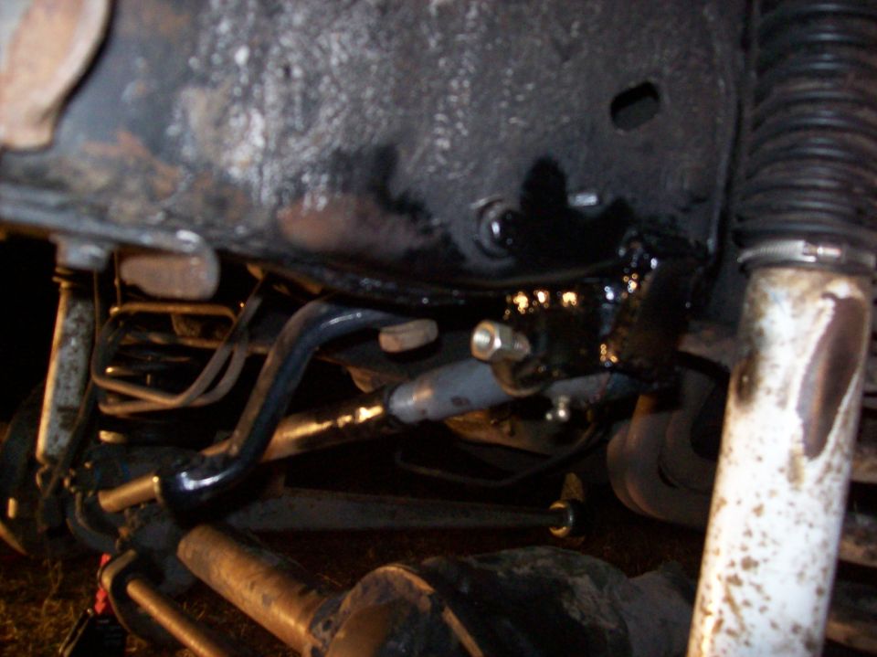 Undercarriage suspension parts with "SUPERMOTORS" text visible