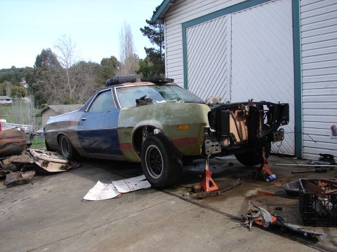 1973 Ford Ranchero - This 1973 Ford Ranchero is in a state of repair, with its front end removed and body panels showing varied colors.