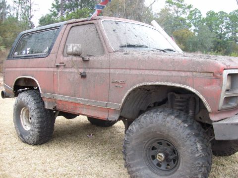 1986 Ford Bronco - This heavily modified 1986 Ford Bronco is covered in mud, oversized tires and a lifted suspension.
