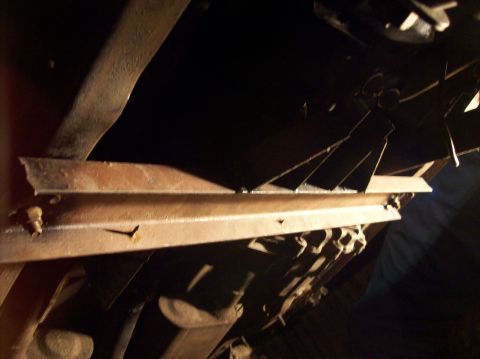 1986 Ford Bronco - Close-up view of the undercarriage, showing structural components and exhaust piping.