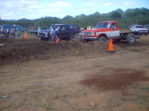 1976 Ford F-100 - A 1976 Ford F-100 chassis navigates a muddy course during a drag event.
