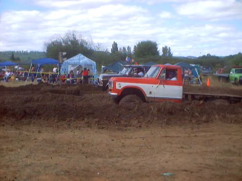 1976 Ford F-100 - Mud drags event with a 1976 Ford F-100 partially submerged in mud.