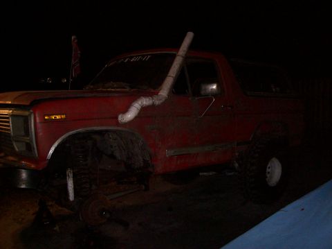 1986 Ford Bronco - This red 1986 Ford Bronco features a snorkel intake and appears to have a lifted suspension.