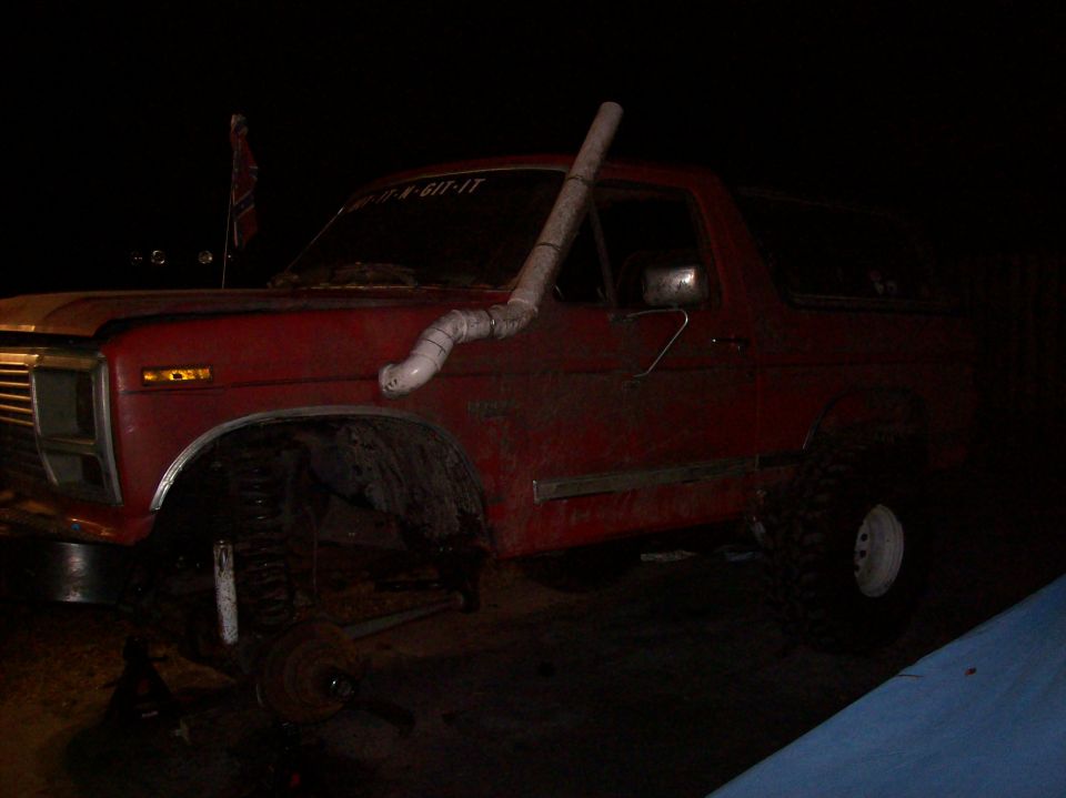 Red 1986 Ford Bronco with snorkel and lifted suspension