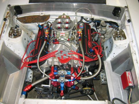 1992 Ford Mustang - The engine bay of a 1992 Ford Mustang shows a V8 engine with performance modifications.