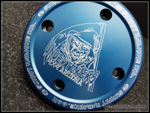 1966 Ford Bronco - Close-up of a blue drive flange cover with engraved graphics and text from Summit Machine Inc.
